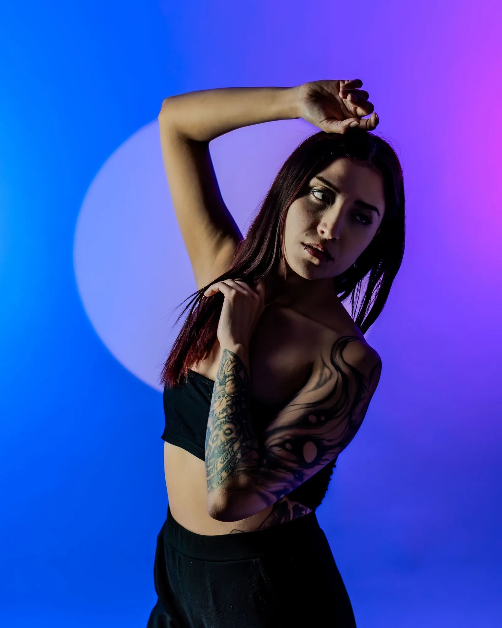 Model in violet light touching her hair