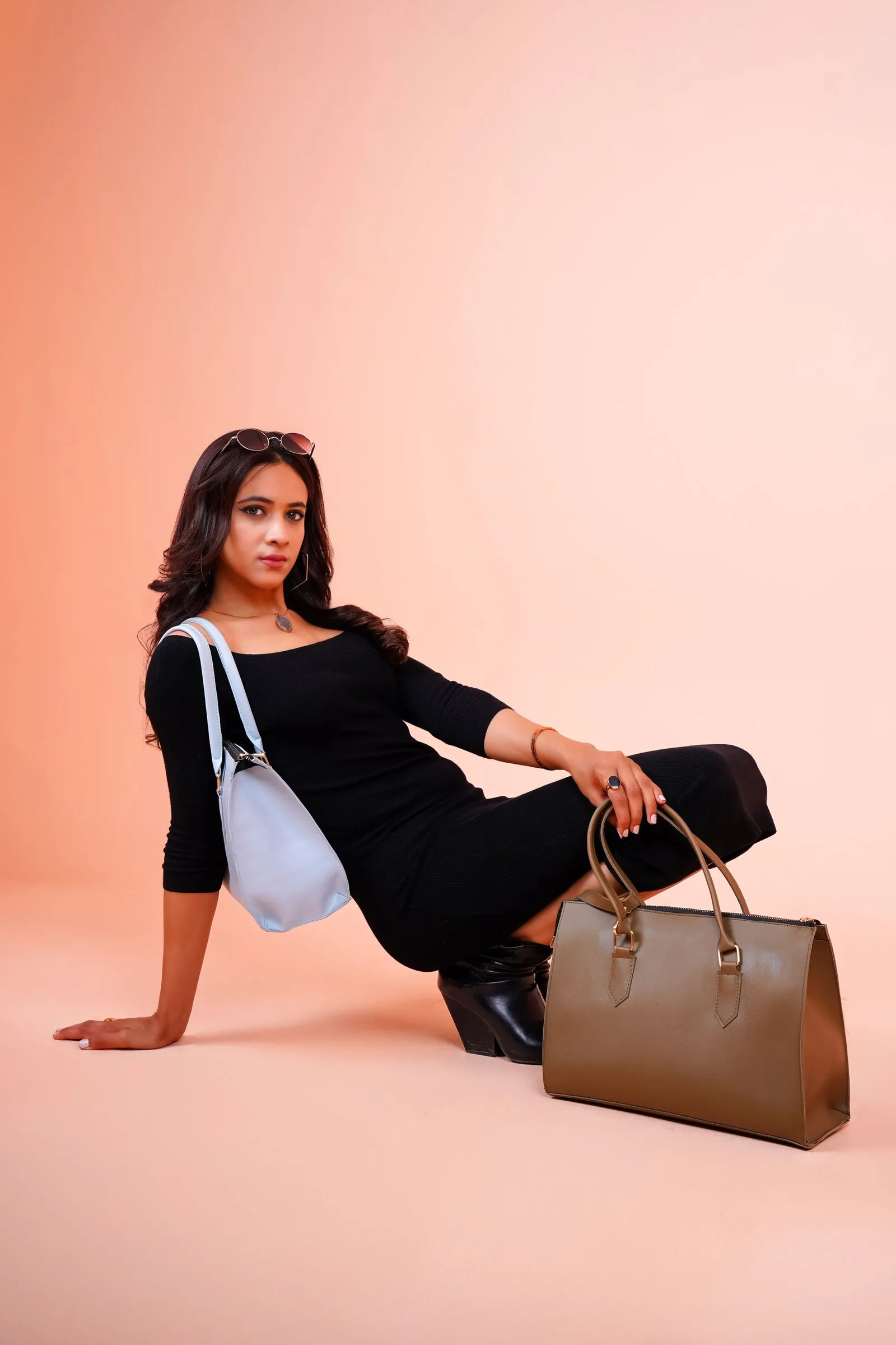 Model seated with a tan holdall