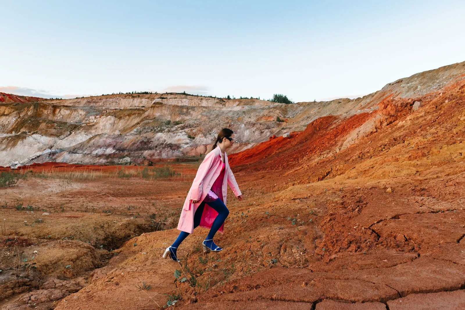 Model walking uphill with the quarry behind her