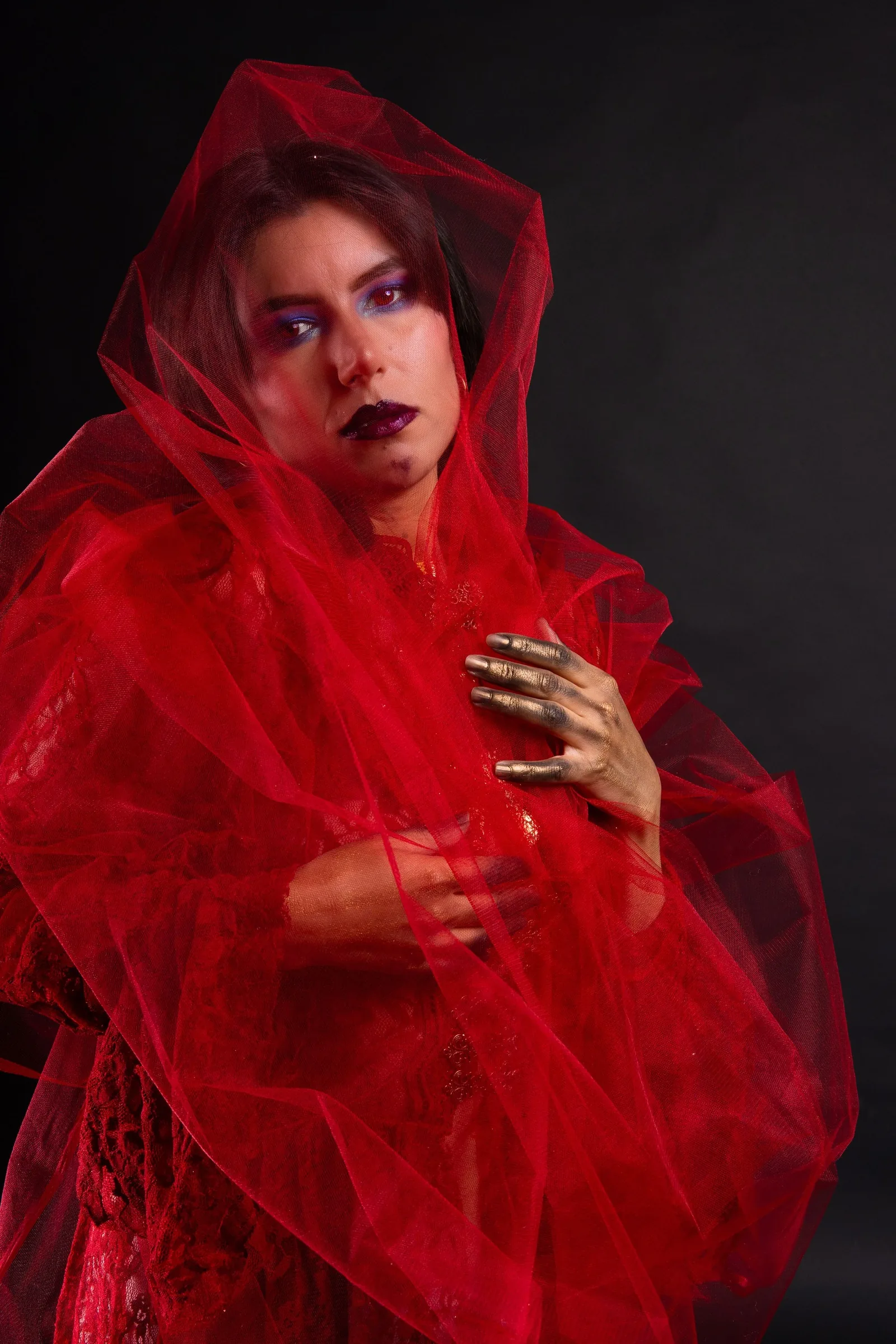 Portrait with red tulle and gold painted hands