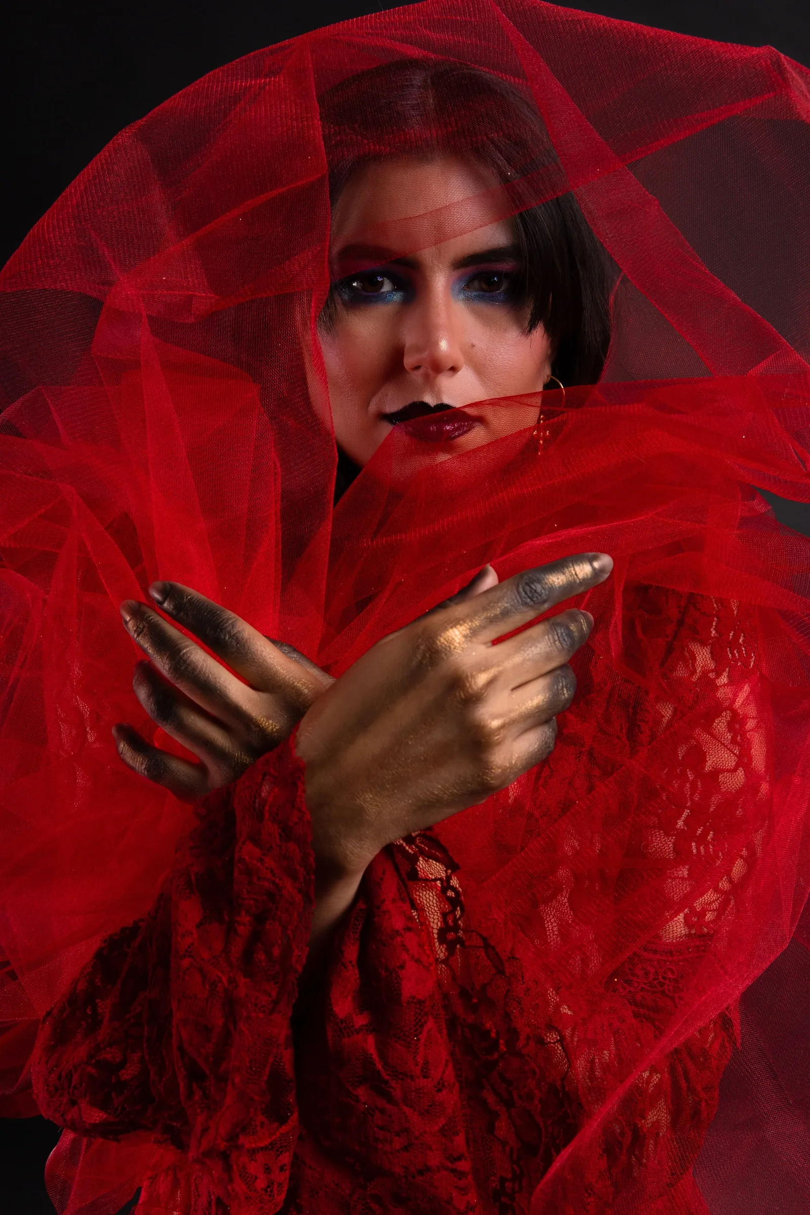 Model with red tulle and blue eye make-up