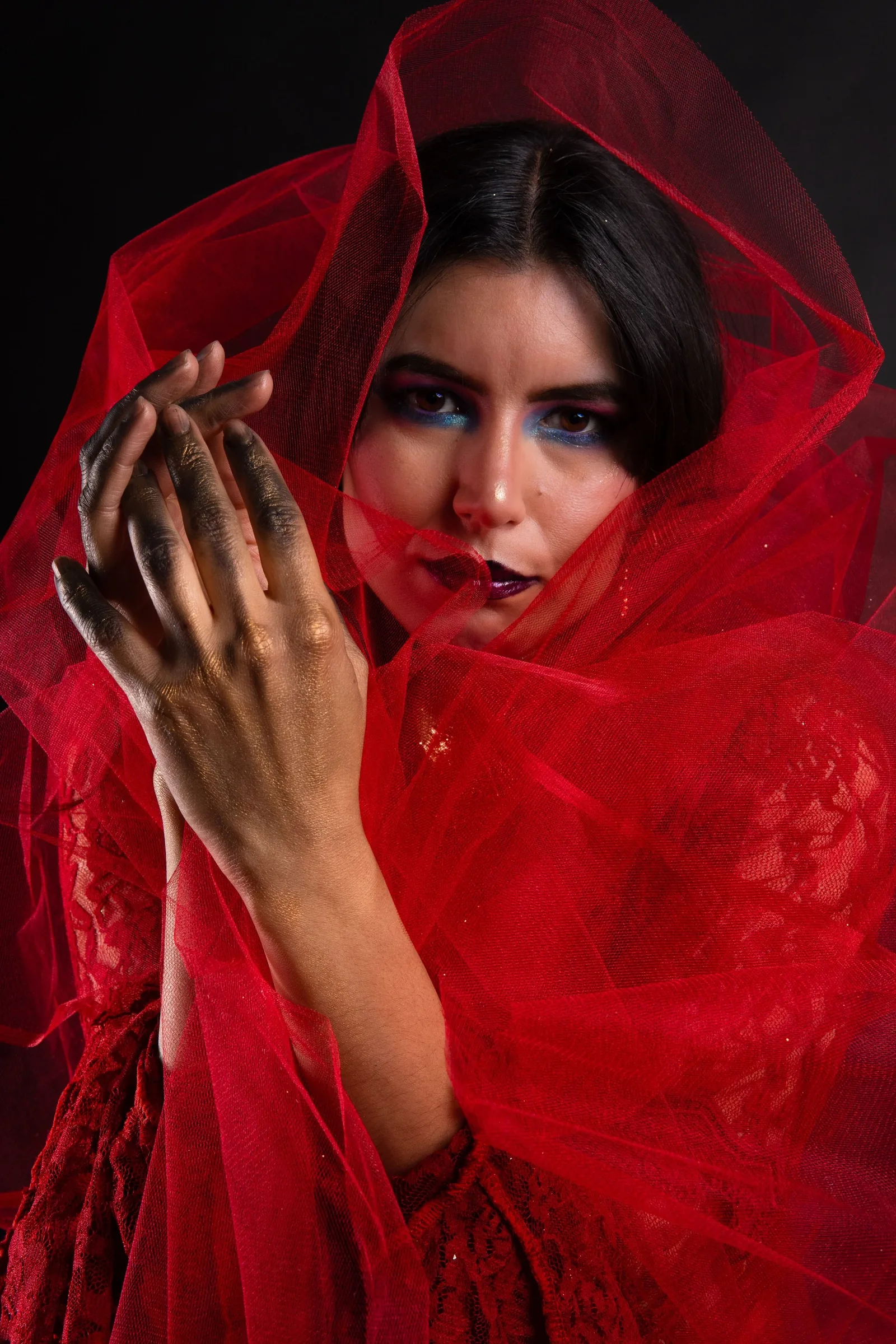 Model looking up from inside red tulle